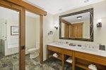 Double stone vanity, and separate water closet with sliding barn type door for privacy